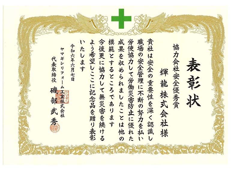 お客様から表彰状を受け取る当社担当者